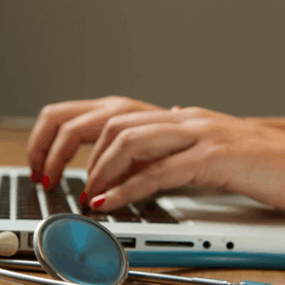 BSH healthcare person typing with statoscope